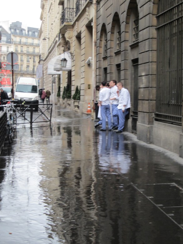 Rainy day, rue Cambon. Students on a cigarrette break from the Ecole Ritz Escoffier, across the street from Chanel Paris.