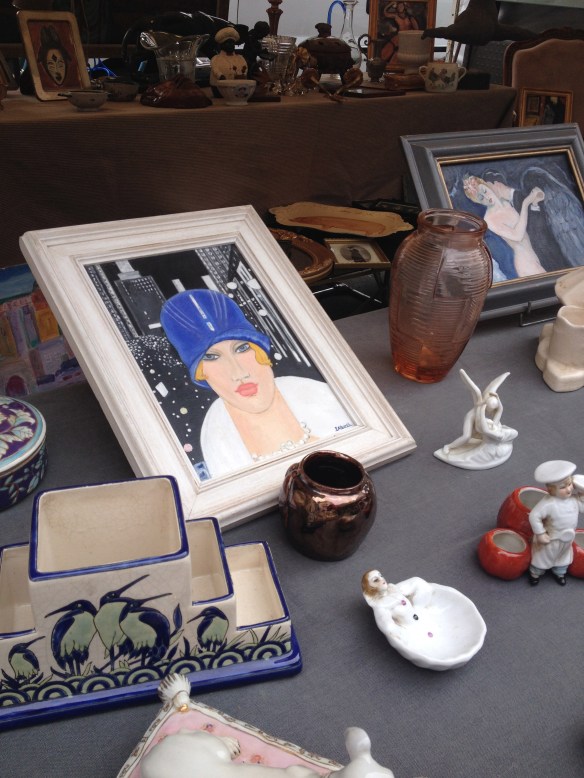 An image of Lee Miller at a brocantes fair on rue Cler in Paris.