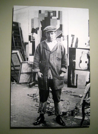 A photograph of Picasso in his rue Schoelcher studio 1915-16. I can almost see what Eva saw in him. . . .